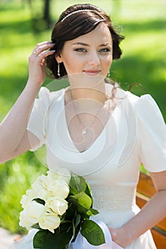Beautiful bride sitting on the bench