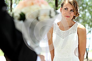 Beautiful bride smile and looking to her groom