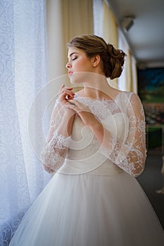 Beautiful bride standing near window