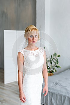 A beautiful bride stands in a wedding dress. Fases.