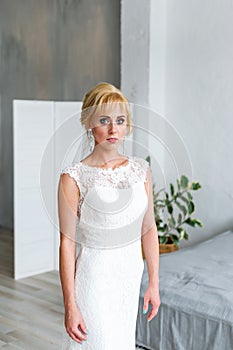 A beautiful bride stands in a wedding dress. Fases. photo