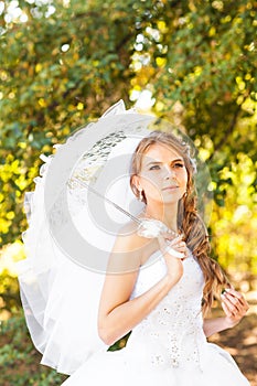 Beautiful bride with stylish make-up in white