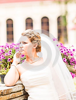 Beautiful bride with stylish make-up in white