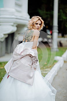 Beautiful bride with tattoo at wedding morning