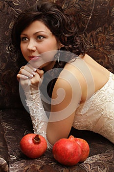 Beautiful bride with three pomegranates