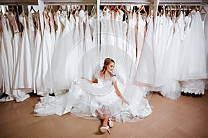 Beautiful bride is trying on an elegant wedding dress
