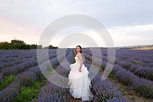 beautiful bride on wedding day in lavender field. Young girl in a white dress in the summer in lavender. Wedding day