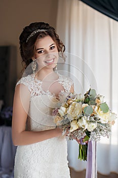 Beautiful bride in wedding dress with bouquet of flowers