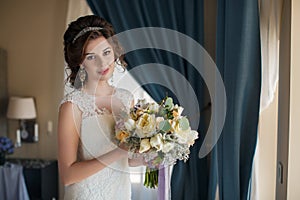 Beautiful bride in wedding dress with bouquet of flowers