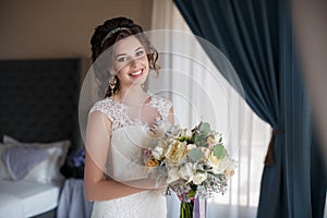 Beautiful bride in wedding dress with bouquet of flowers