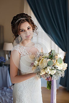 Beautiful bride in wedding dress with bouquet of flowers