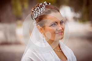 Beautiful bride in wedding dress and bridal bouquet, happy newlywed woman with wedding flowers, woman with wedding makeup and hair