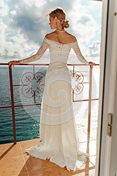 Beautiful Bride in wedding dress, outdoor portrait. Brunette elegant woman in luxurious fashion white gown enjoying on