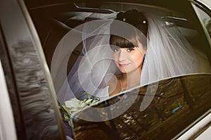 Beautiful bride in wedding limousine