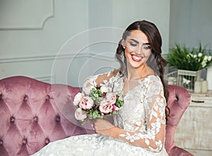 Beautiful bride with wedding makeup, dress and jewelry on long hair