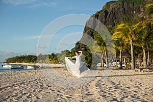 Beautiful bride in white dress on the beach.