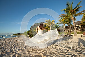 Beautiful bride in white dress on the beach.