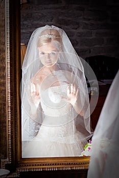 Beautiful bride in white infront of mirror