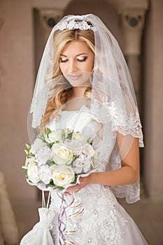 Beautiful bride woman with bouquet of flowers, wedding makeup an