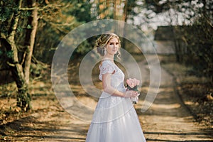 Beautiful bride woman portrait with bridal bouquet posing in her wedding day