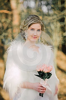 Beautiful bride woman portrait with bridal bouquet posing in her wedding day