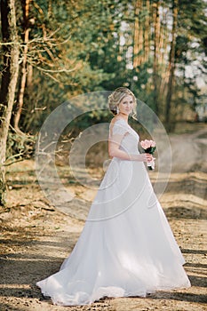 Beautiful bride woman portrait with bridal bouquet posing in her wedding day