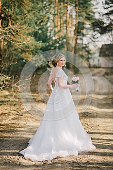 Beautiful bride woman portrait with bridal bouquet posing in her wedding day