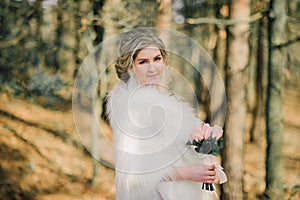 Beautiful bride woman portrait with bridal bouquet posing in her wedding day