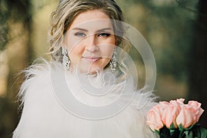 Beautiful bride woman portrait with bridal bouquet posing in her wedding day