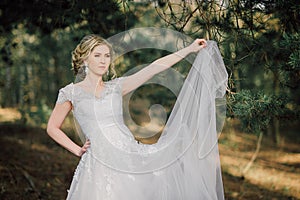 Beautiful bride woman portrait with bridal bouquet posing in her wedding day