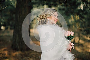 Beautiful bride woman portrait with bridal bouquet posing in her wedding day