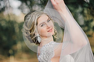 Beautiful bride woman portrait with bridal bouquet posing in her wedding day