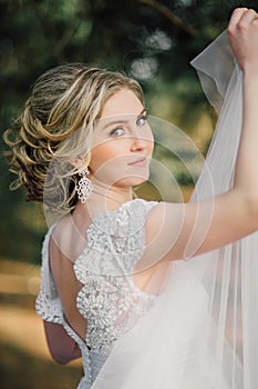 Beautiful bride woman portrait with bridal bouquet posing in her wedding day