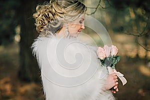 Beautiful bride woman portrait with bridal bouquet posing in her wedding day