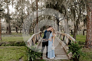 Beautiful Bridesmaid Woman in Blue Dress and Bouquet with Her Date at a Formal Wedding Party Celebration Event Outside in the Wood