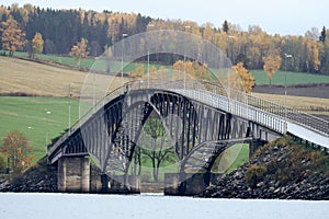 Beautiful bridge over the Nes and Helga, ya Island in Lake Mja, a cloudy day in autumn. photo