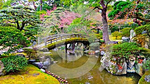 Beautiful bridge upon small pond in the Japanese style garden