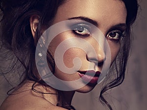 Beautiful bright amzing face makeup woman posing with burgundy lipstick and vamp look. Closeup photo