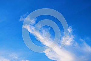 Beautiful bright blue sky with unique shape of cloud.