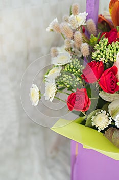 beautiful bright bouquet in a purple basket on a white background, copy space