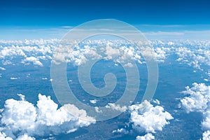 Beautiful bright clear blue sky with tiny cloud out of the airplane for background.