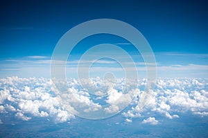 Beautiful bright clear blue sky with tiny cloud out of the airplane for background.