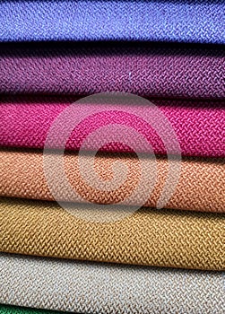 Beautiful bright collection of colorful fabric or textile samples. Fabric texture background