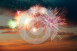 Beautiful bright fireworks lighting up twilight sky outdoors
