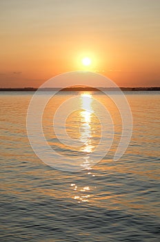 Beautiful bright orange summer sunset on the sea. Sun and solar