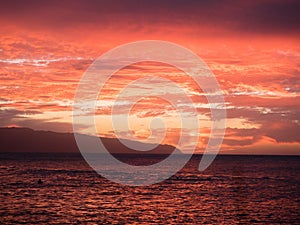 Beautiful bright red sunset over the ocean at the Honululu city in Hawaii islands