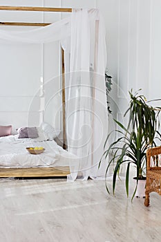 Beautiful bright room and a four-poster bed