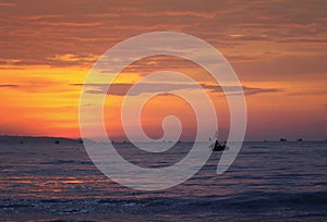 beautiful bright seascape red sunset , blue the sea and the silhouette of the fishing boats