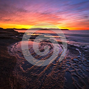 Beautiful bright sunrise over Kiddies Corner on Umina Beach on NSW Central Coast in Australia