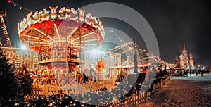 Beautiful brightly glowing carousel on the Red Square decorated and arranged for Christmas and New Year. Christmas fairy photo